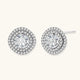 Double halo sterling silver stud earrings with brilliant round moissanite center stones and pavé crystal accents