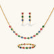 Gold-plated jewelry set with red, green, and blue cubic zirconia stones including necklace, bracelet, and drop earrings.