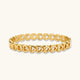 Gold 18K plated stainless steel bangle with continuous open heart links, high-polish finish, on white background.